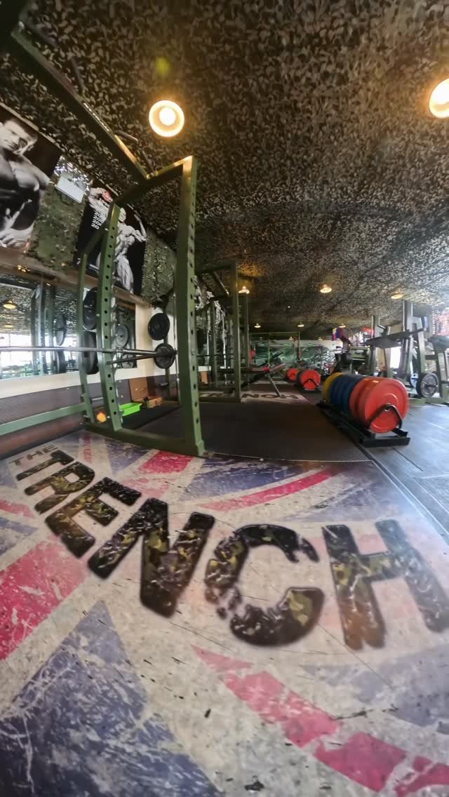 The word TRENCH painted on the Union Jack floor downstairs, with squat racks behind